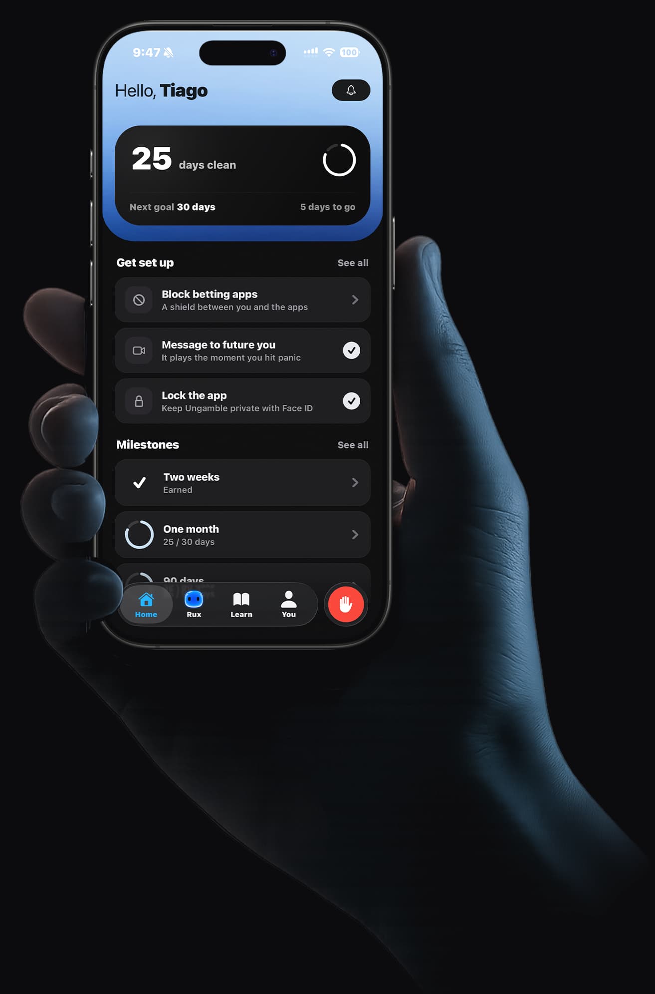 A hand holding an iPhone with the Ungamble home screen