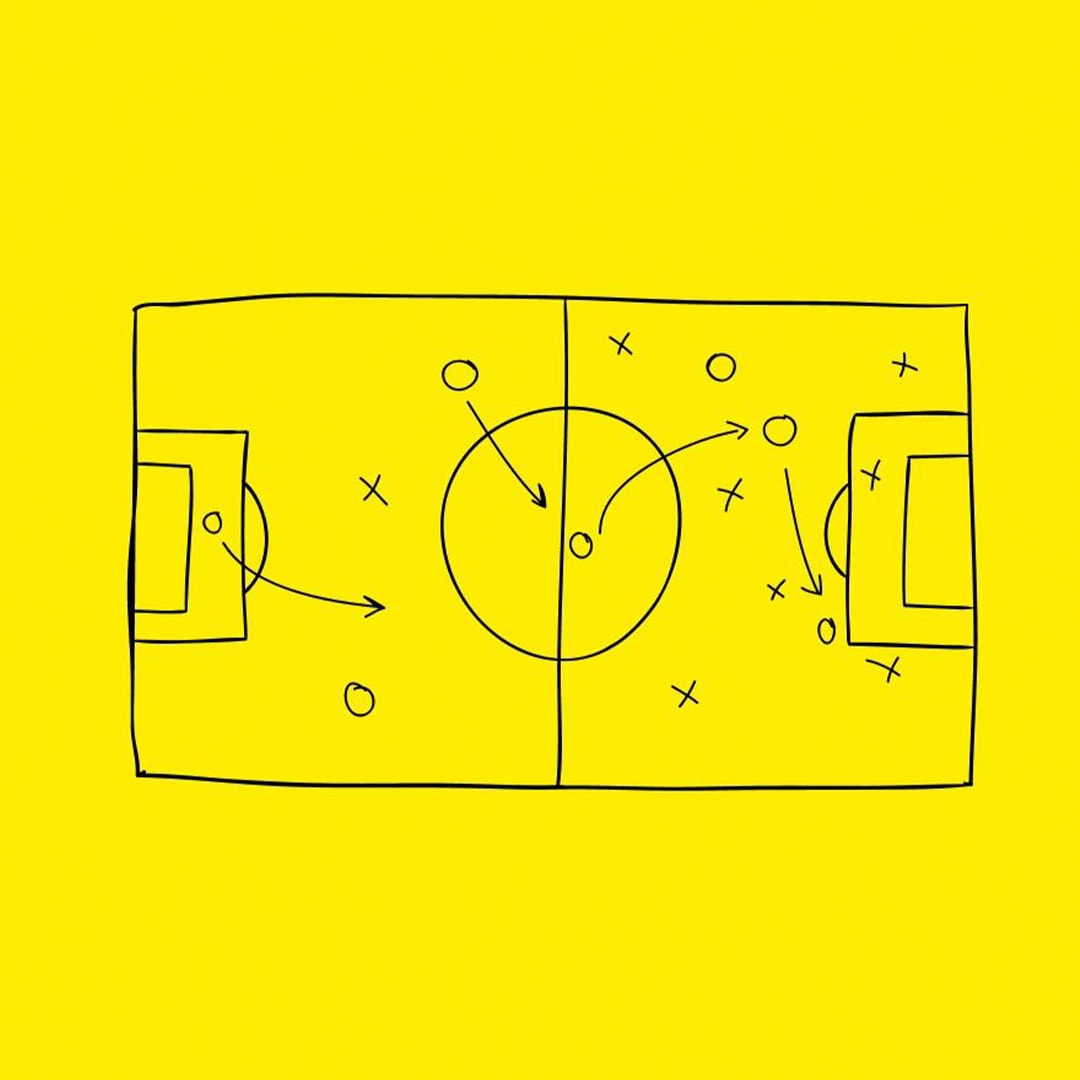 A hand-drawn football tactics board on bright yellow, with players marked as circles and crosses and arrows plotting a move